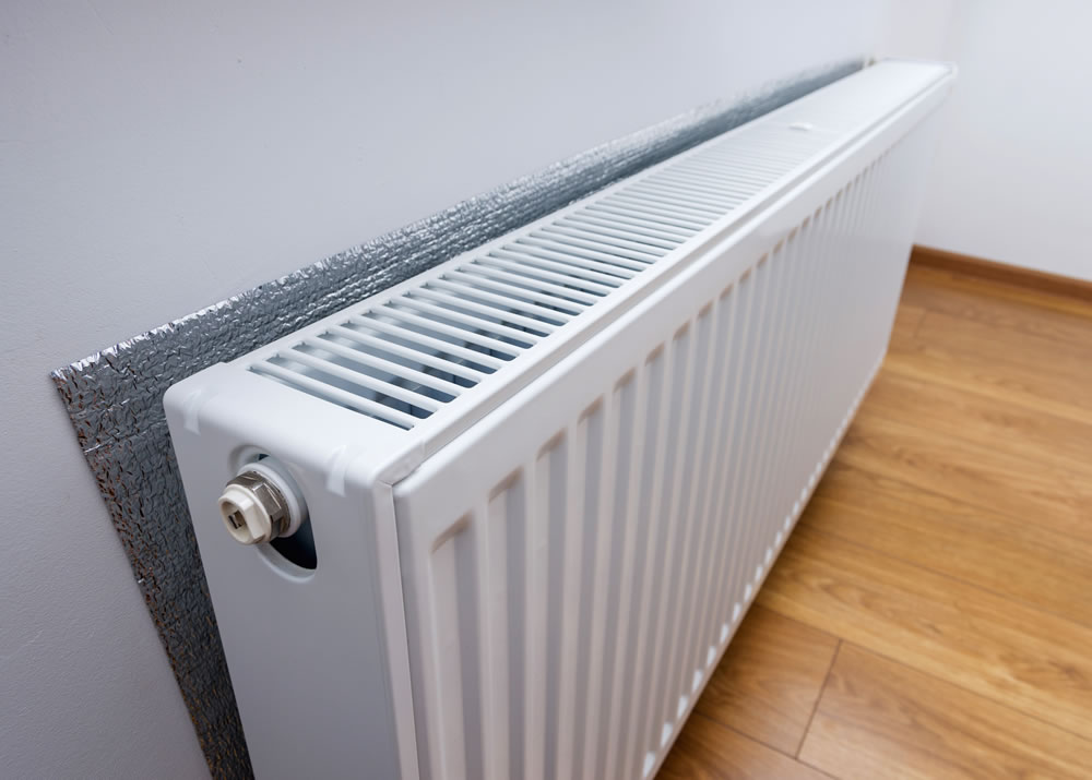 Radiator with foil behind to help heat a room